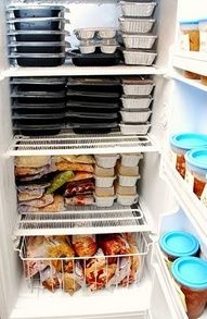 A standup domestic freezer packed full of pre prepared frozen meals