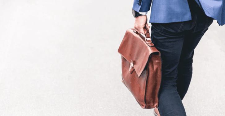 businessman walking with his leather bag